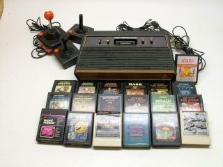   ATARI 2600 GAME WOOD GRAIN CONSOLE SYSTEM WITH GAMES CONTROLLERS NTSC