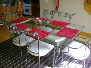 Wrought iron kitchen table with glass top and 6 padded chairs