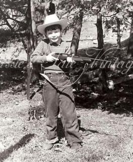     Little Boy in Cowboy Hat Holding a Rifle, Chipmunk Cheeks   1958