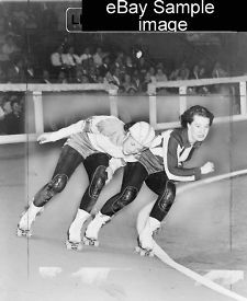 1950 TITLE Swinging down the track. Two women compete in roller derby 