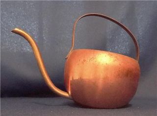 The body is made of solid copper and the handle~spout is made of brass