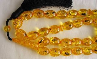   Amber Color Resin with one or more insects in each and very bead