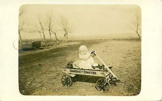 baby in white is posed in new somerset coaster wagon w/steel wheels