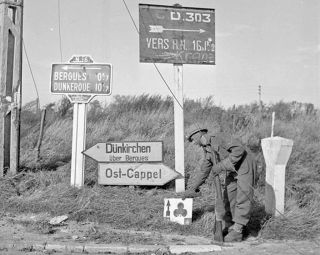 Royal Canadian Engineers placing a sign Dunkirk 1944